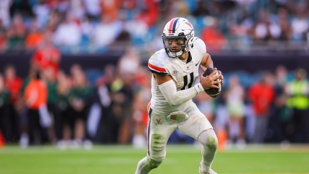 Virginia Cavaliers quarterback Tony Muskett (11) runs with the ball against the Miami Hurricanes during the fourth quarter at Hard Rock Stadium.